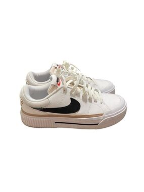 Nike White Low-Top Sneakers with Black Swoosh and Tan Stripe